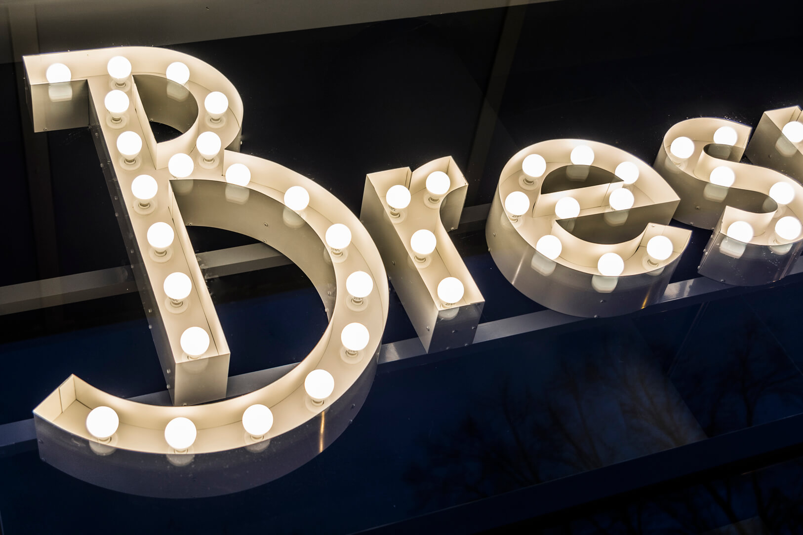 Bresno - letters with light bulbs behind glass